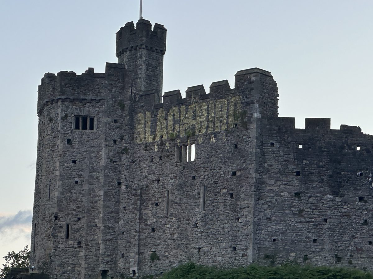 Cardiff Castle with the Blackbird Festival logo projected on its keep
